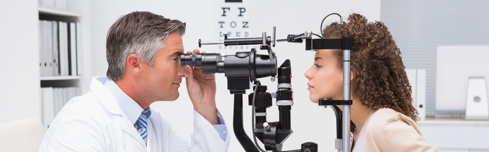 eye doctor checking a patient's eyes